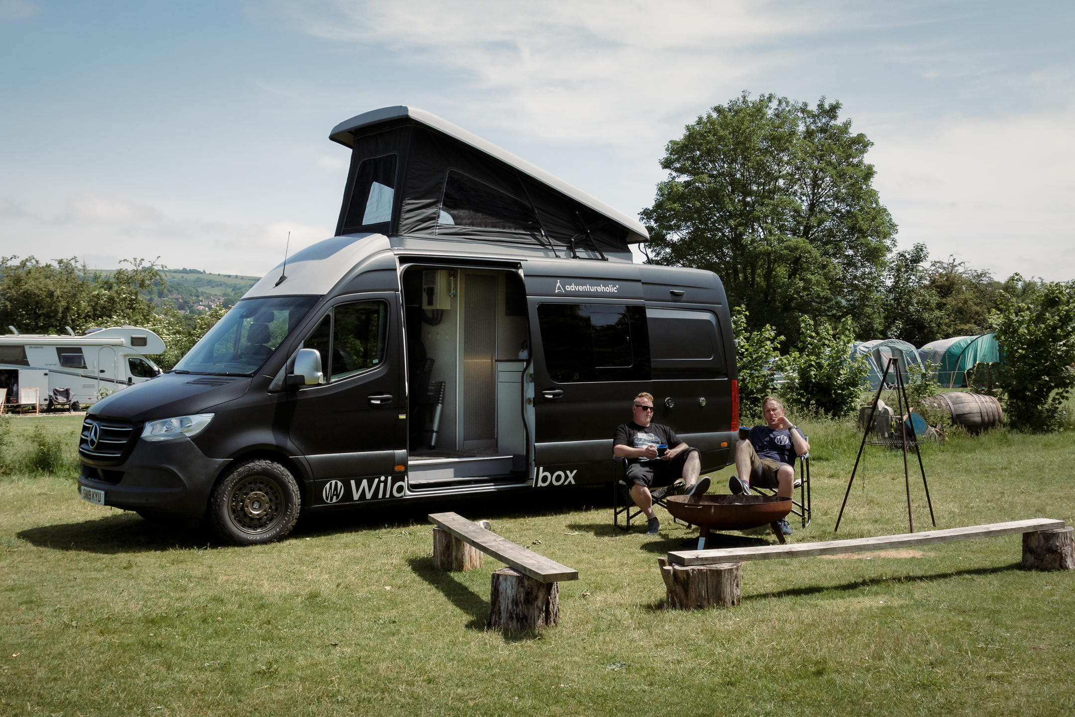 Avandra van with camping setup and people relaxing outside
