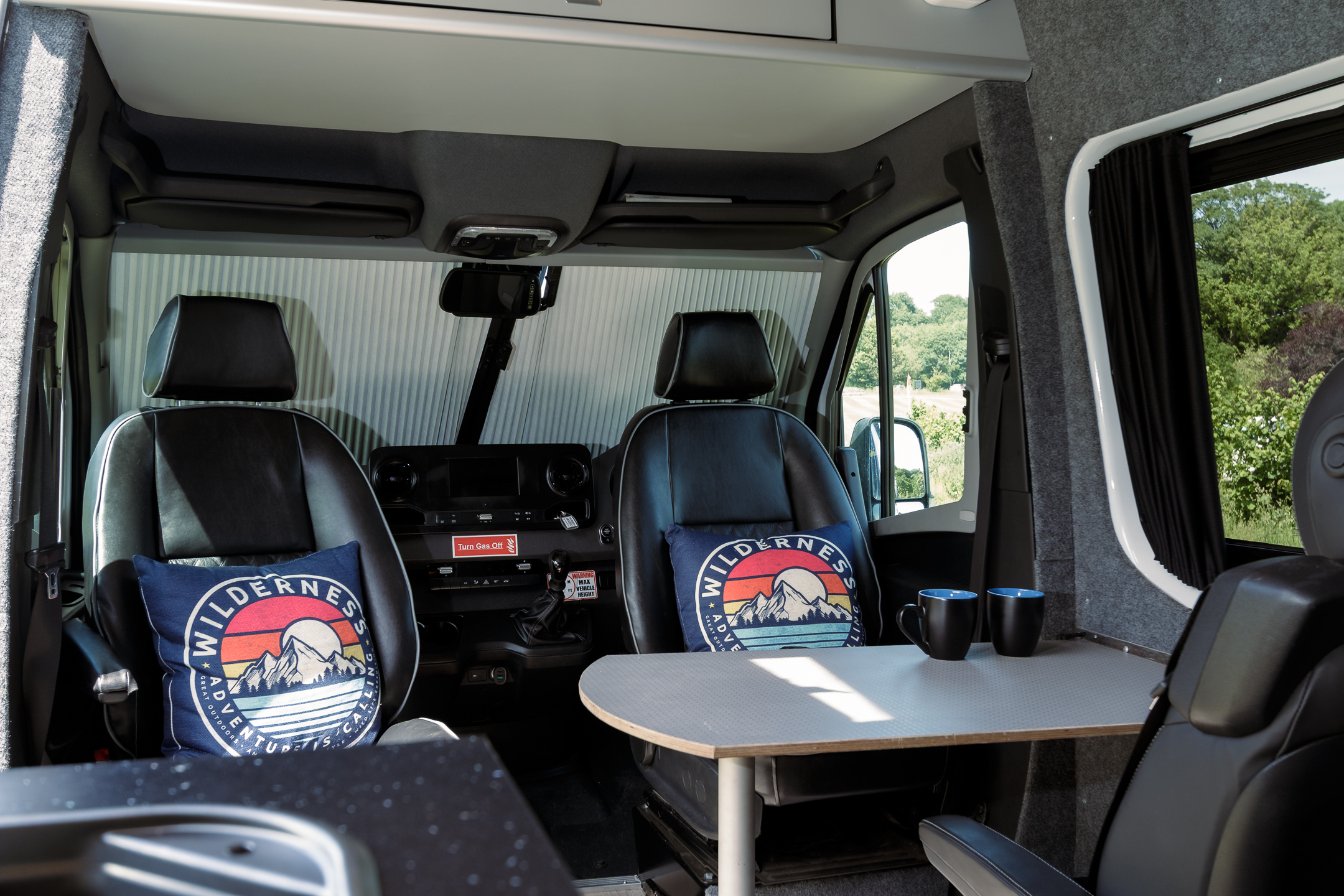 Interior view showing leather captain's seats and demountable table
