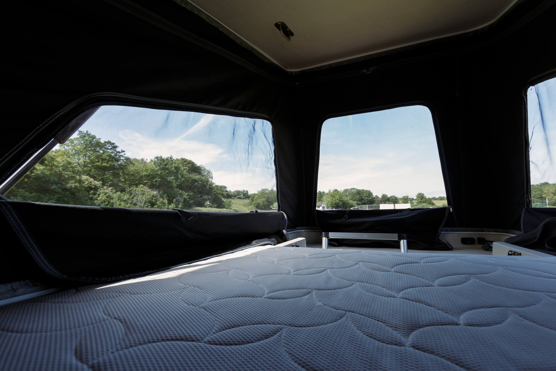 Pop-top double bed with memory-foam mattress and panoramic windows