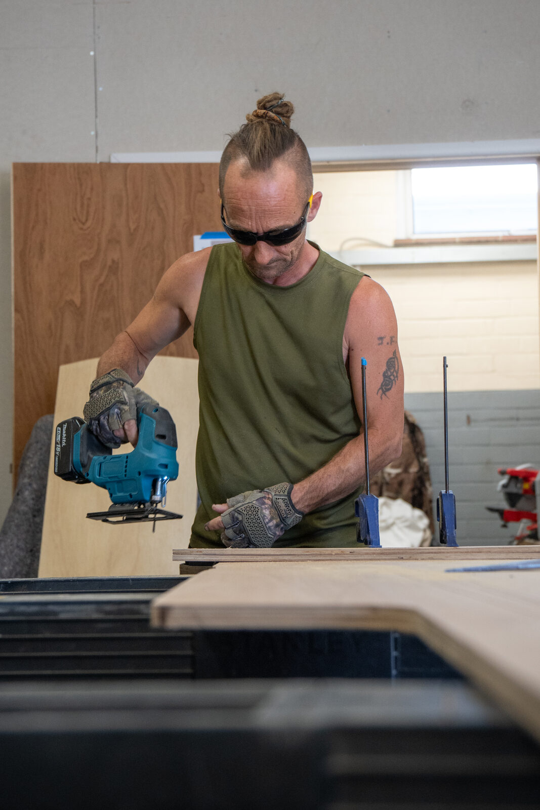 Matt shaping a panel with a jigsaw in the workshop