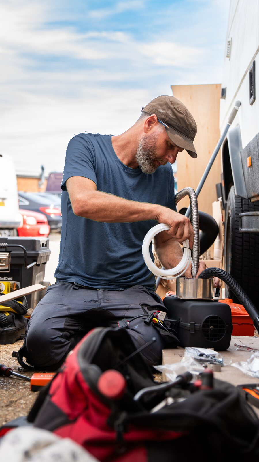 Mick fitting equipment beside a vehicle